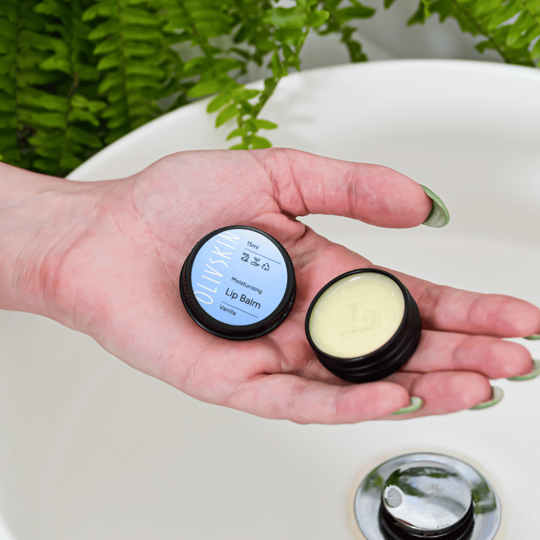 Olivskin Vanilla Lip Balm open in hand showing the balm texture