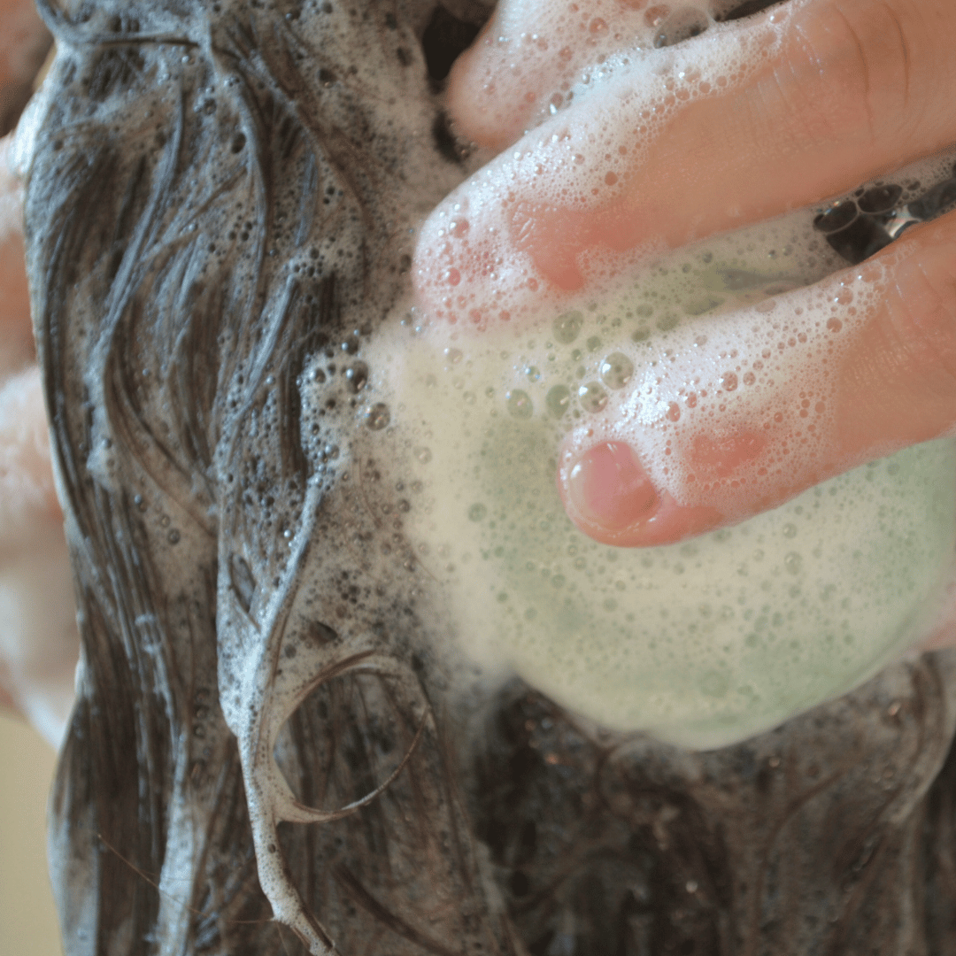 Olivskin Shampoo Block creating a rich lather in wet hair