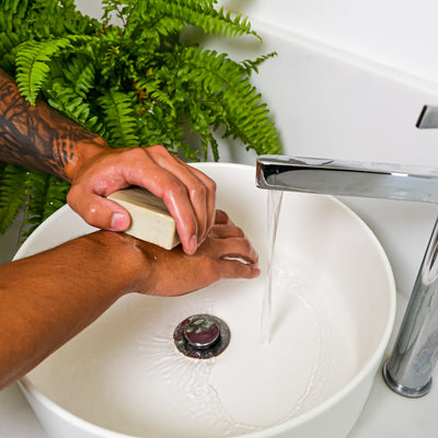lemon and orange soap block in use on hands