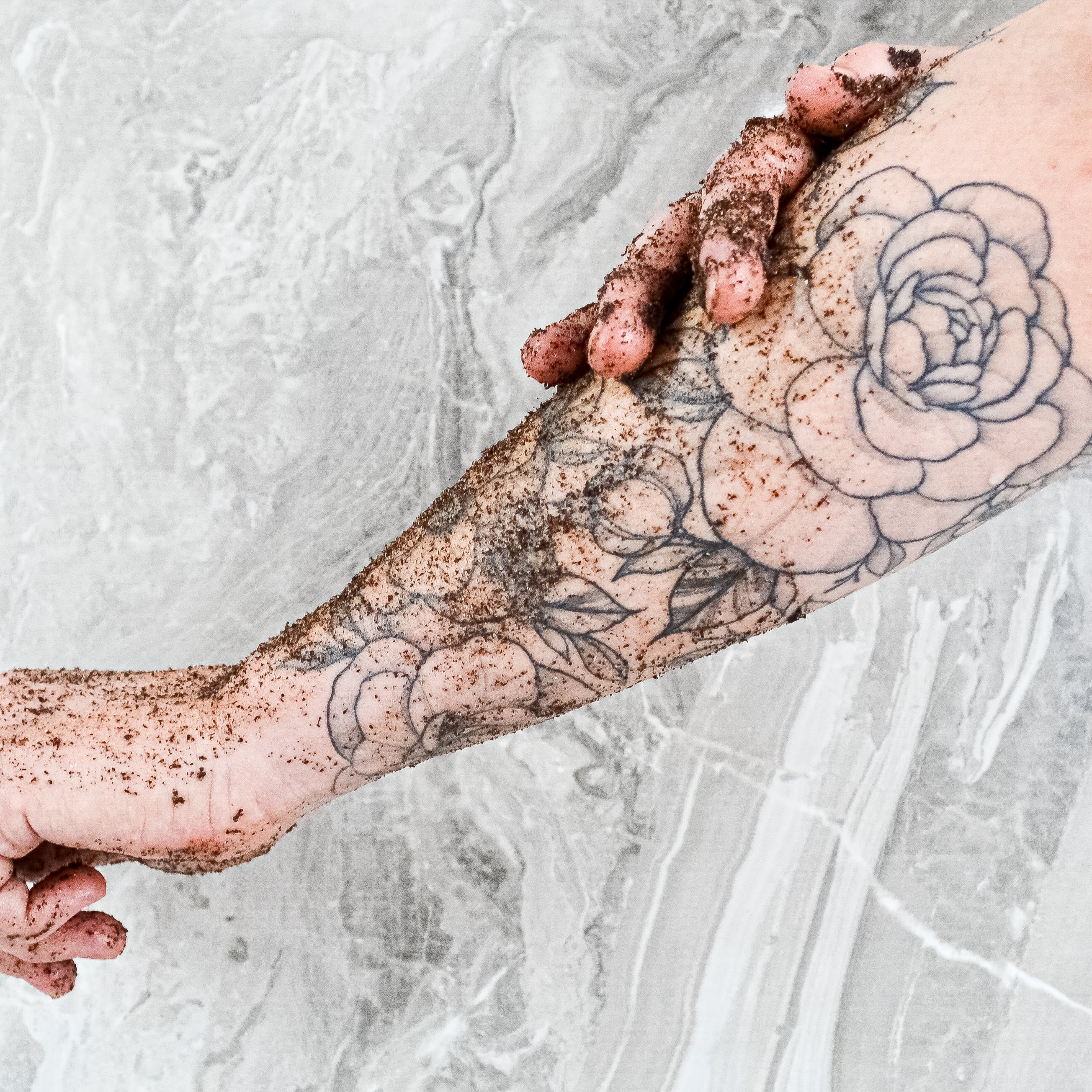 coffee scrub being used on arm